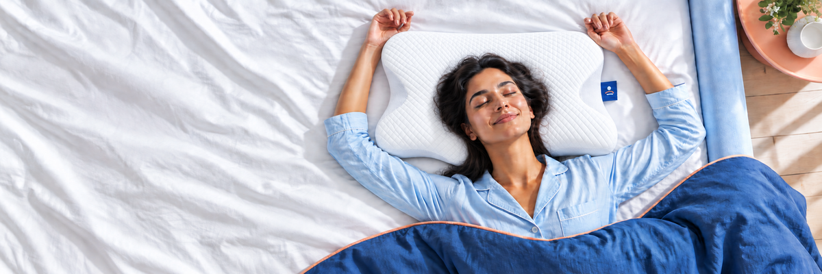 A side sleeper resting on a white contoured pillow